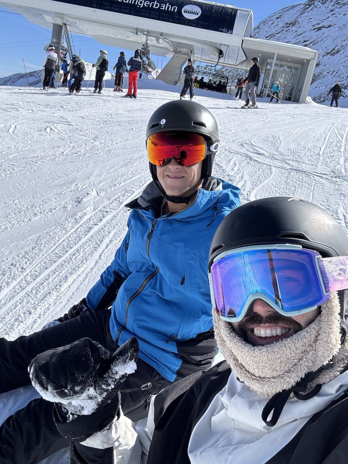 Michael and Andrew sitting in the snow next to the lift station