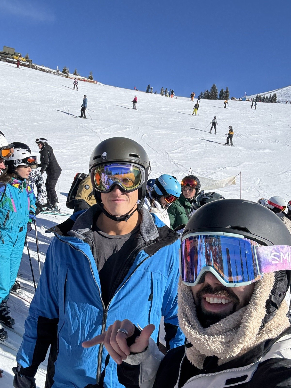 Andrew and Michael in a busy lift line on a sunny day